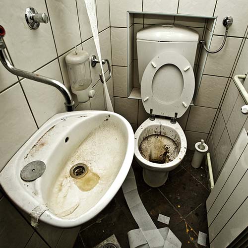 filthy toilet and sink in tiny bathroom